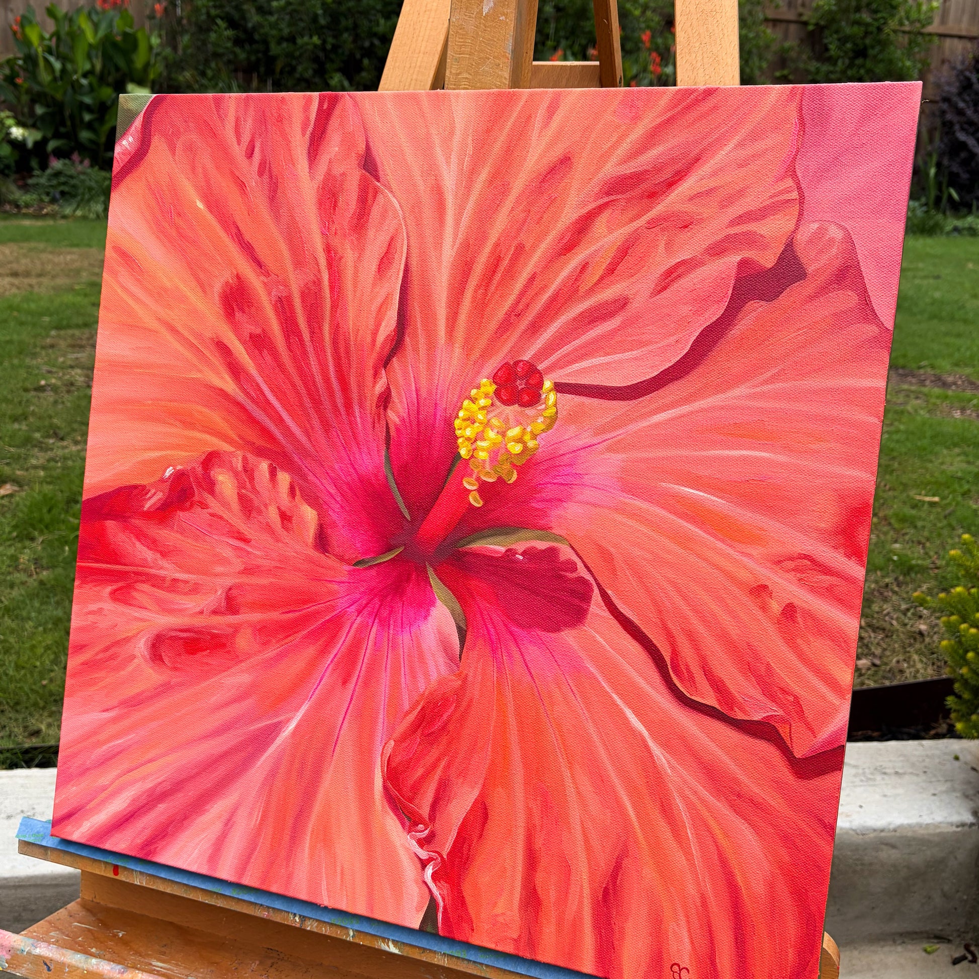 painting of tropical red hibiscus on easel